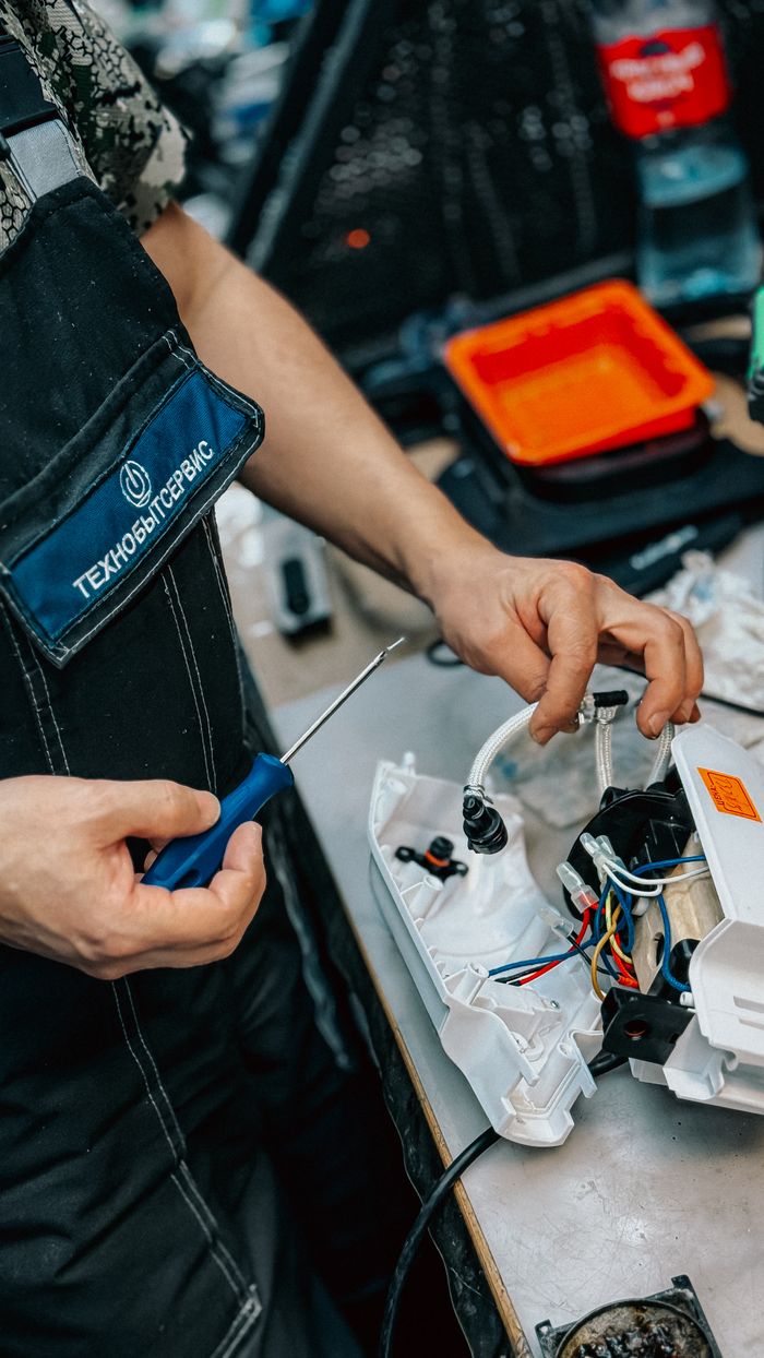 Crafting Captivating Headlines: Your awesome post title goes here Close-up of a technician using a screwdriver to repair an electrical device in a workshop setting.