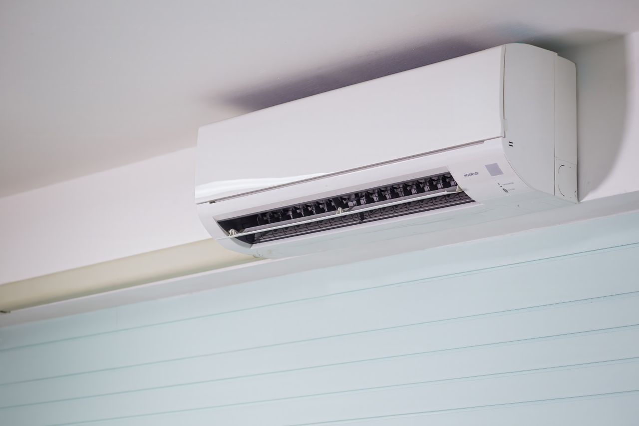 why-choose-us-03 Close-up of a wall-mounted air conditioner indoors, showcasing sleek design for modern cooling solutions.